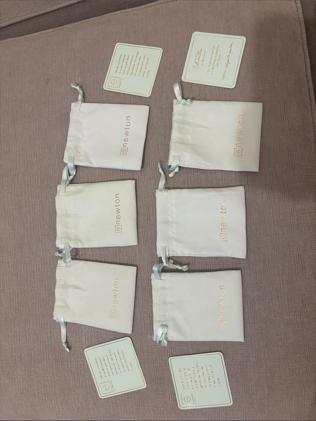Newton Cream Satin Drawstring Pouches With Gold Logo (Set Of 6, But Can Buy 1)
